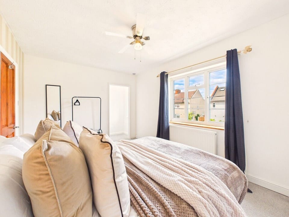 Bright and airy bedroom with a king-size bed, high-quality linens, and a dedicated clothing rack. Enjoy the calming atmosphere and modern design of this peaceful space