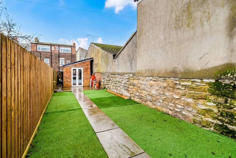 French doors open onto the leafy back garden and walled outdoor space.