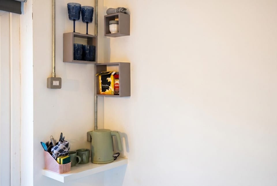 Handy tea and coffee station with kettle, mugs and Kenco favourites.