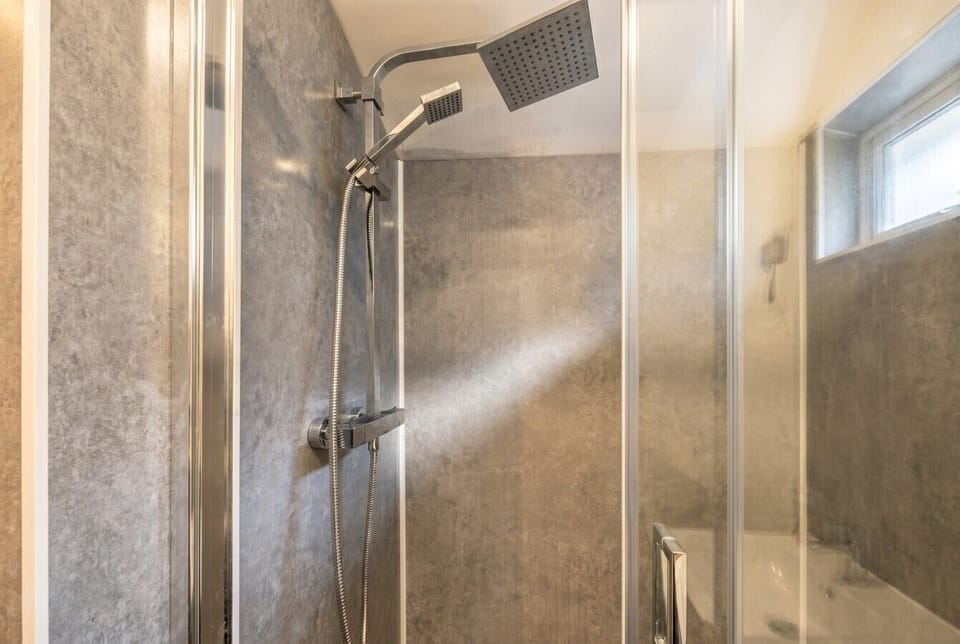 Powerful rainfall shower with handheld option for a refreshing start.