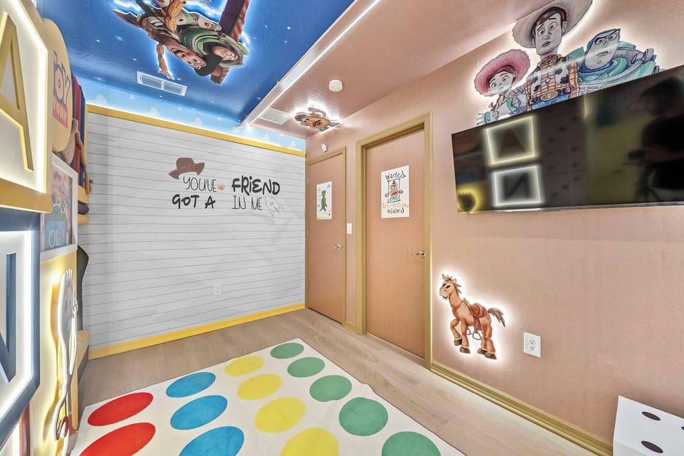 Step into a playful haven where vibrant colors and whimsical decor spark joy. The cheerful polka dot rug complements the thoughtfully designed wall graphics, creating a delightful atmosphere perfect for family fun and relaxation.