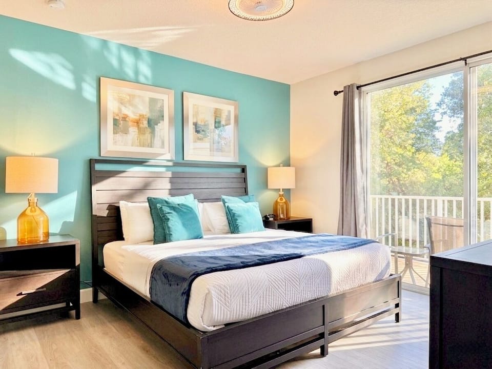 Wake up to golden treetop views! Private balcony steps from your luxury king bed