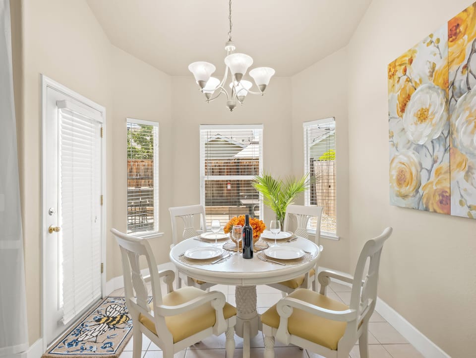 Enjoy meals in this charming dining area featuring comfortable seating, abundant natural light, and easy access to both the kitchen and outdoor living spaces.