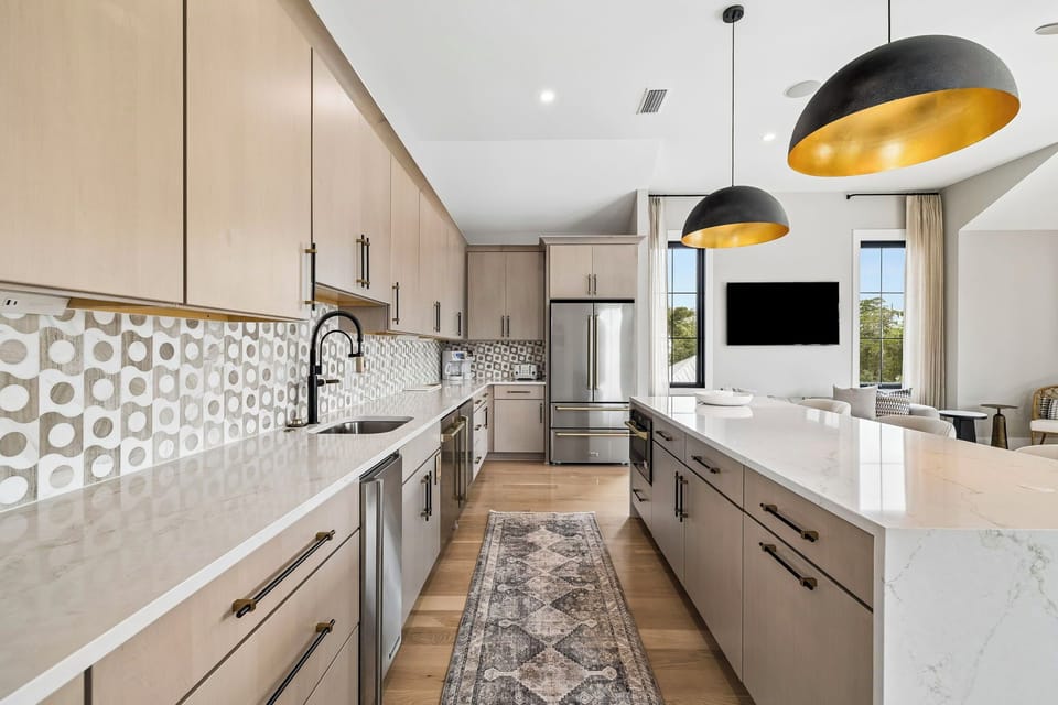 Step into your dream kitchen with gleaming marble counters, sleek cabinetry, and stylish gold-accented lighting. Cook with ease using top-tier stainless steel appliances while soaking in natural light.