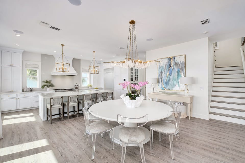 Gather around the elegant dining table under a stunning chandelier, then move to the spacious kitchen island for casual meals and conversation.