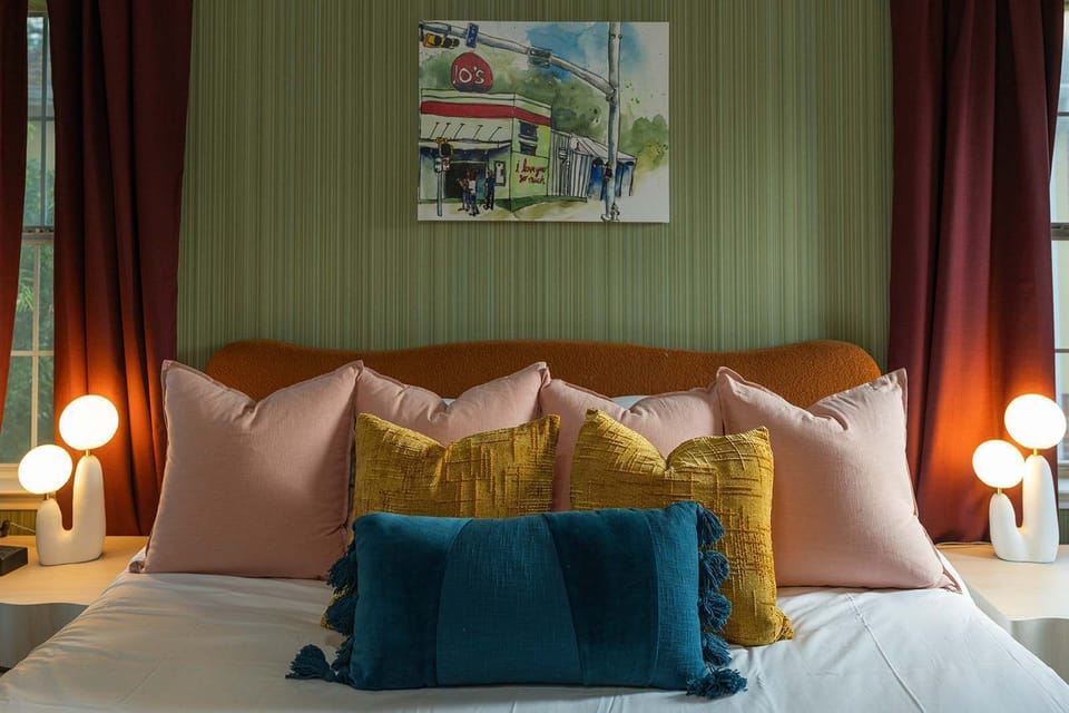 Plush pillows, warm bedside glow, and curated art above — every detail in this king bed is designed for a dreamy night's sleep. 