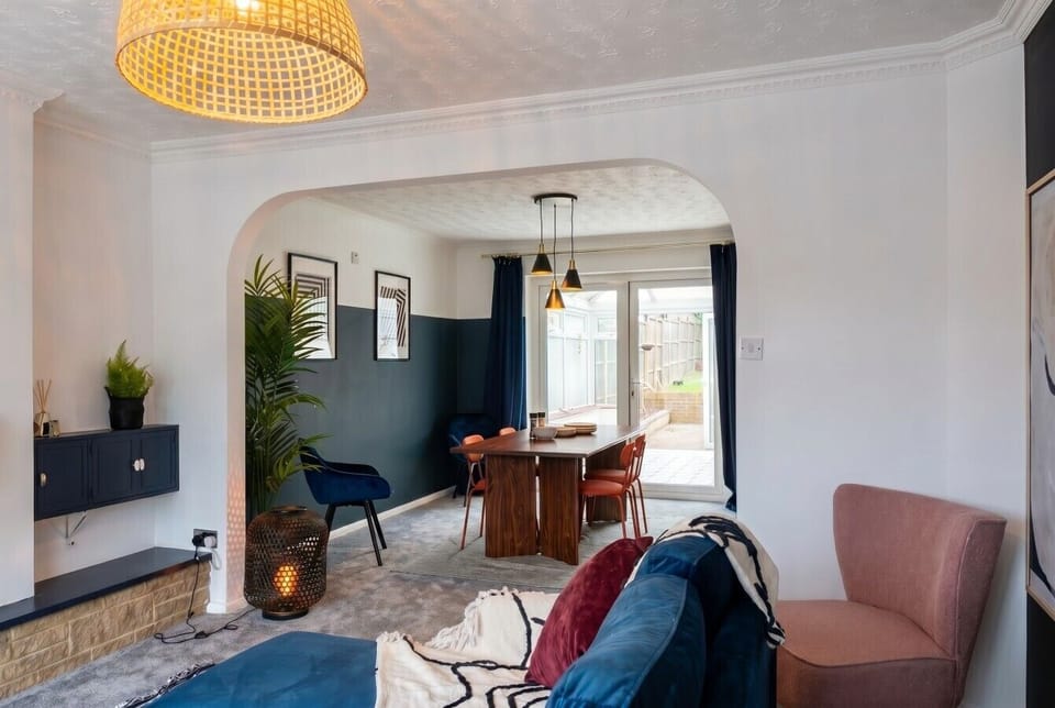 Open archway flows from the snug lounge into a stylish dining space.