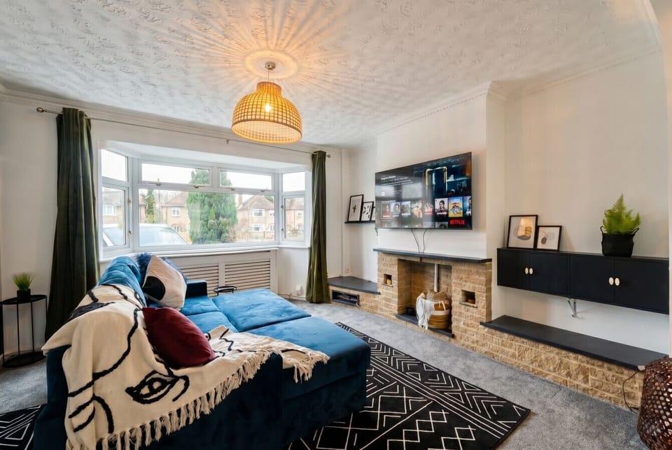 Relax by the fire with Netflix ready to stream from the deep blue sofa.