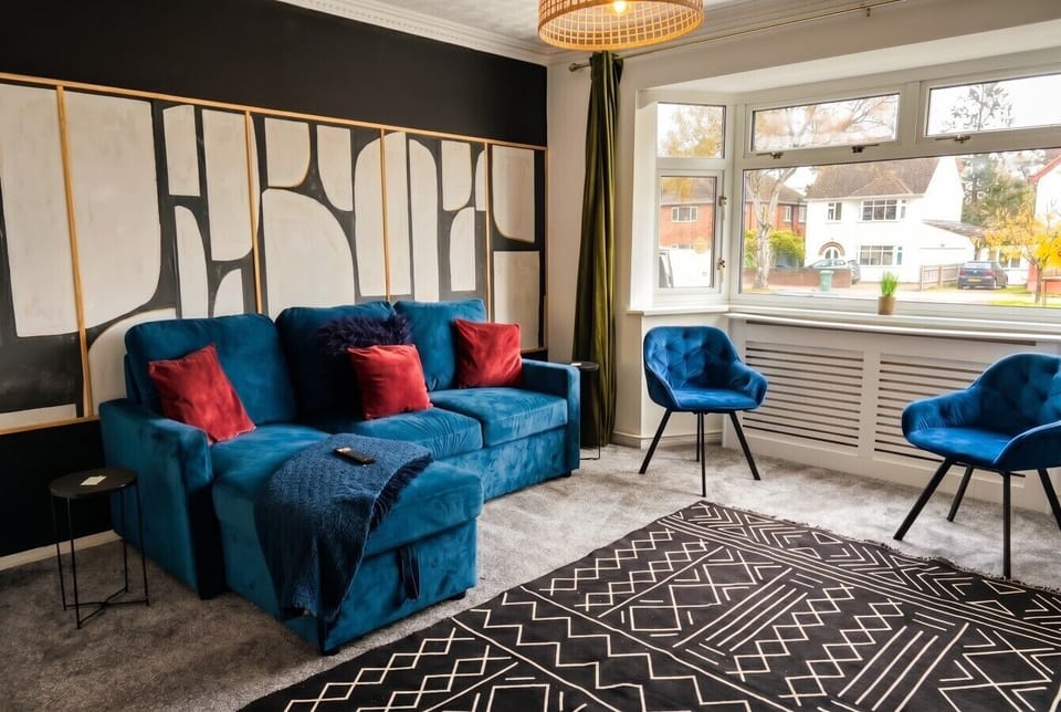 Sink into the blue velvet sofa in this bright bay-window lounge.