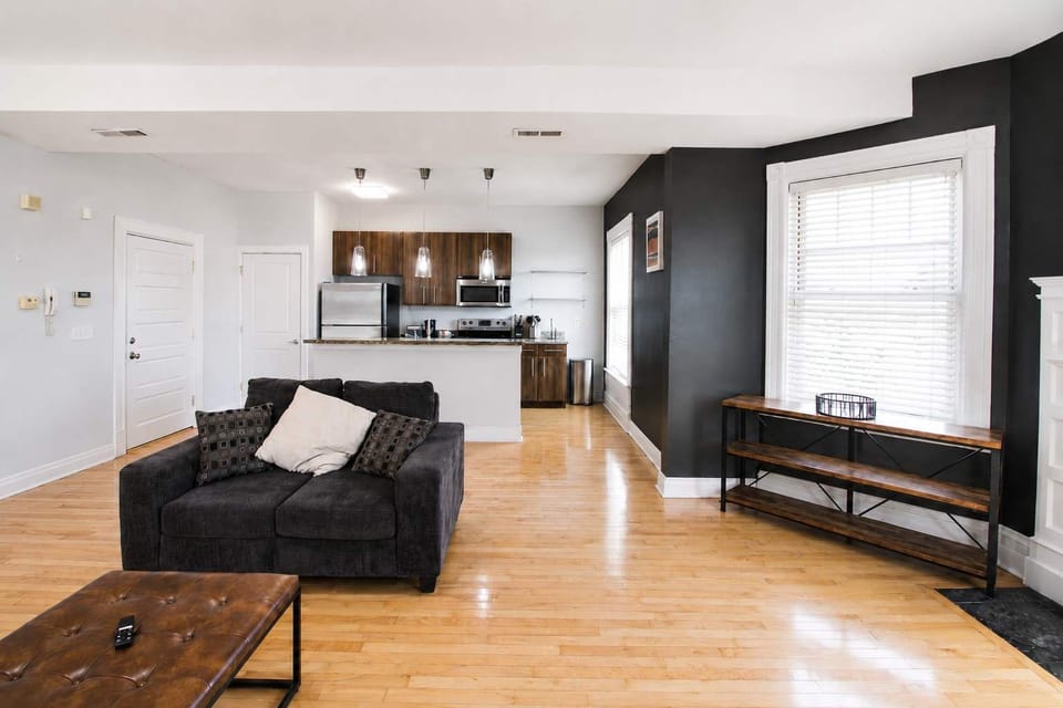 Living room — sofa and big windows over South Grand