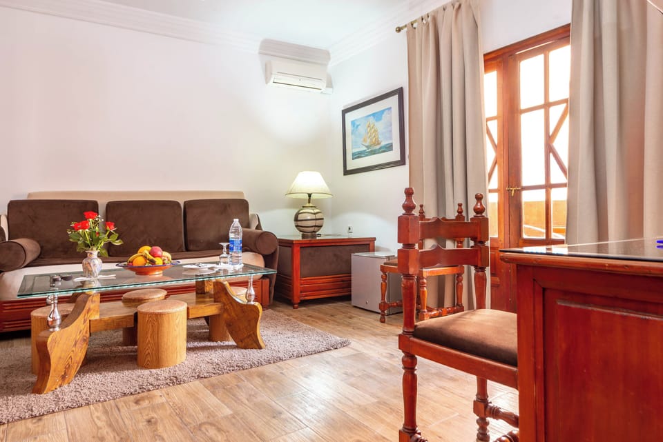 Standard Quadruple Room | Living area | Flat-screen TV