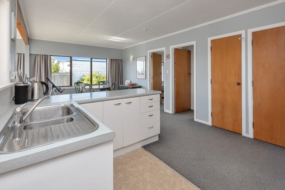 Practical kitchen setup leading through to the dining area and bedrooms.