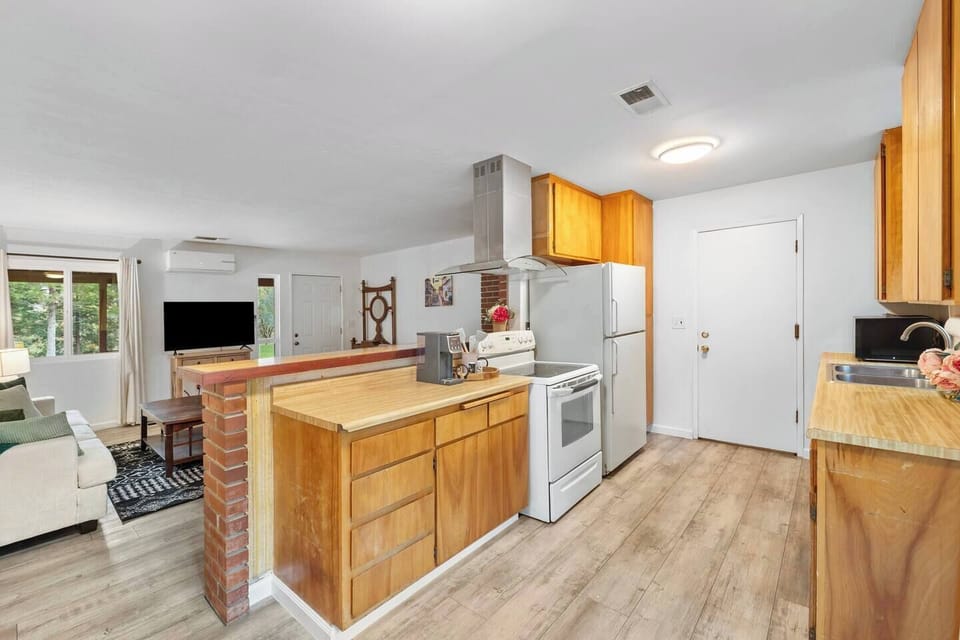 Bright, fully stocked kitchen with full-size appliances and generous counter space, perfect for cooking family meals after a day in the mountains.