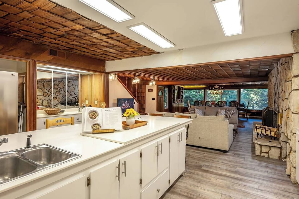 Expanded kitchen with long breakfast bar, lots of prep space, and open sightlines to the living area so the cook never misses the fun.