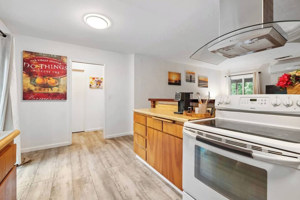 Well-equipped kitchen with full-size stove, generous counter space, and open layout so the chef can stay part of the conversation.