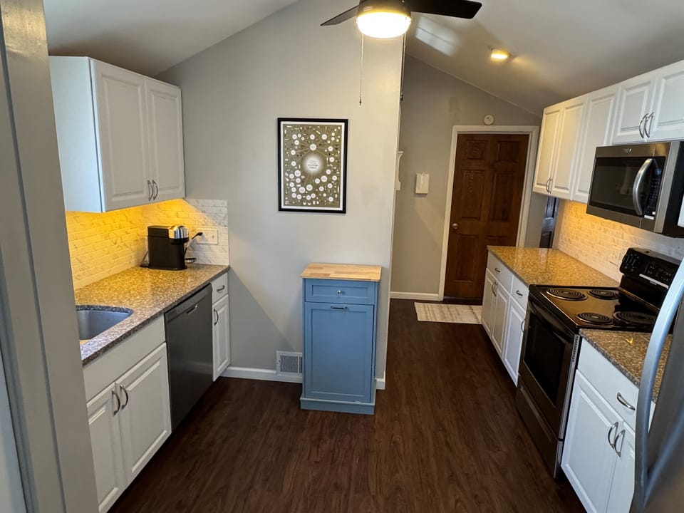 Kitchen: Dishwasher, electric stove, brand new Nespresso Vertuo, drip coffee maker, assortment of utensils and kitchen gadgets
