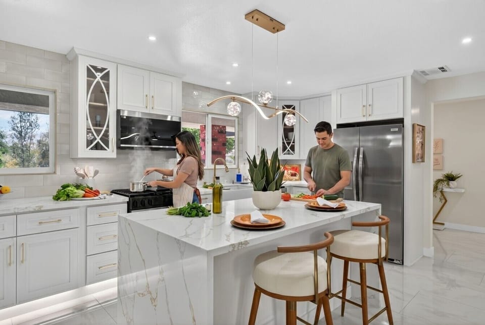 Chef-ready kitchen with high-end appliances, coffee station, and counter seating for casual mornings.