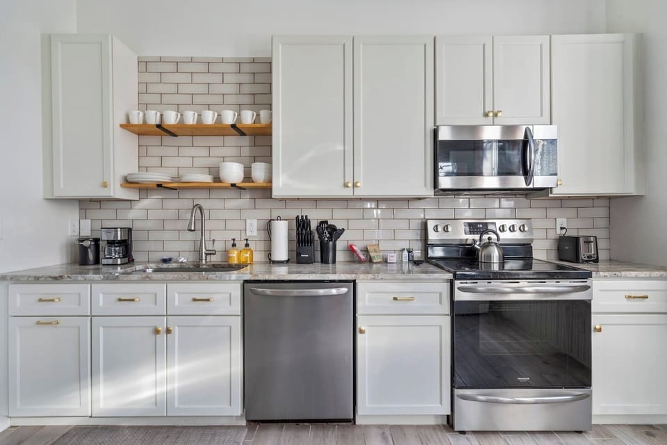 Fully stocked kitchen with stainless appliances, subway tile, and everything you need to cook