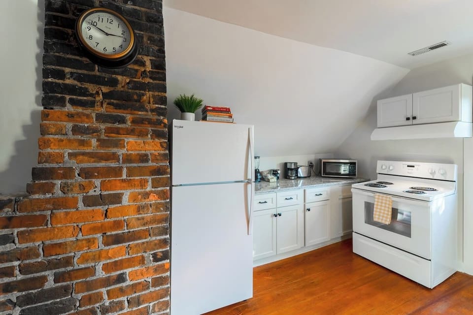 Original exposed brick in the kitchen. Enjoy some complimentary water bottles in the refrigerator. Cookbooks are provided if you feel like staying in for a home-cooked meal.