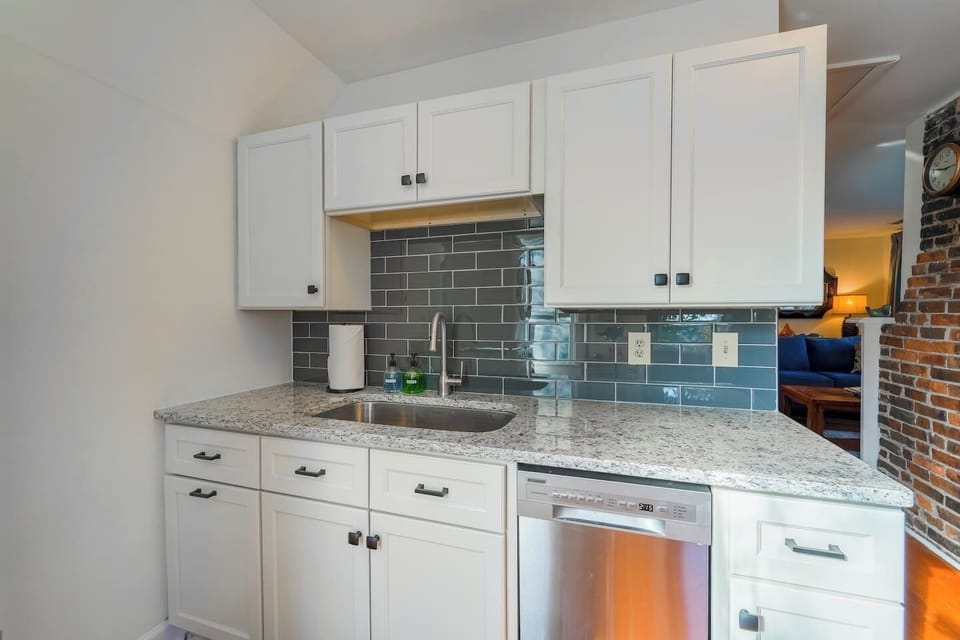 Fully stocked kitchen with a dishwasher, and garbage disposal. 