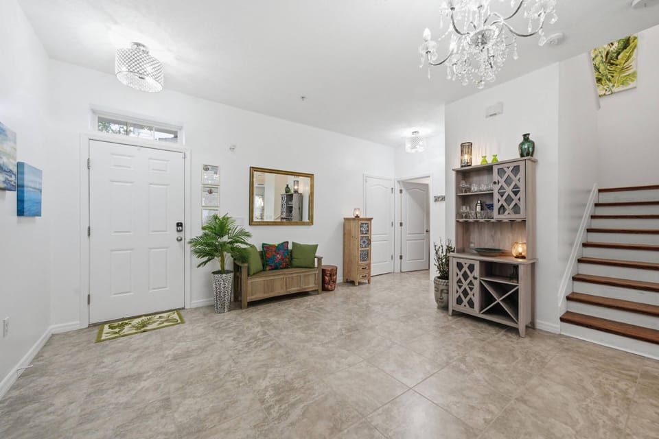 Spacious entry with bar tools in the dedicated bookcase and half bath on the first floor for your convenience.