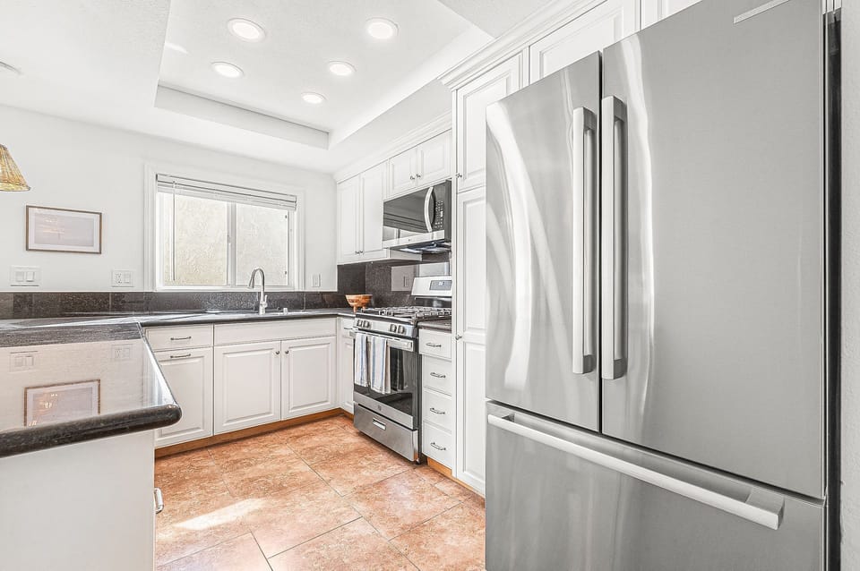 Modern kitchen with stainless steel appliances and ample prep space
                