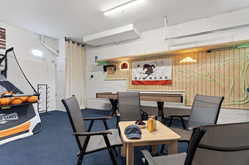 This converted garage game room also features a full-sized shuffleboard table for endless indoor entertainment.