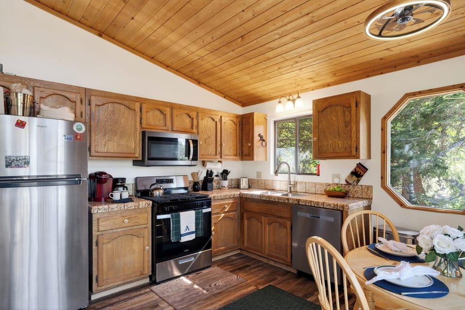 The fully equipped kitchen features classic wood cabinetry, modern appliances, and durable countertops for all your culinary needs.