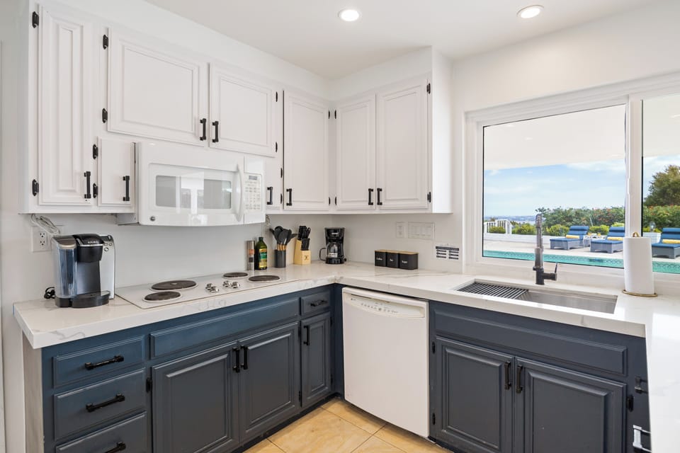 Bright kitchen with pool views, generous counter space, and easy flow into the open living and dining area.