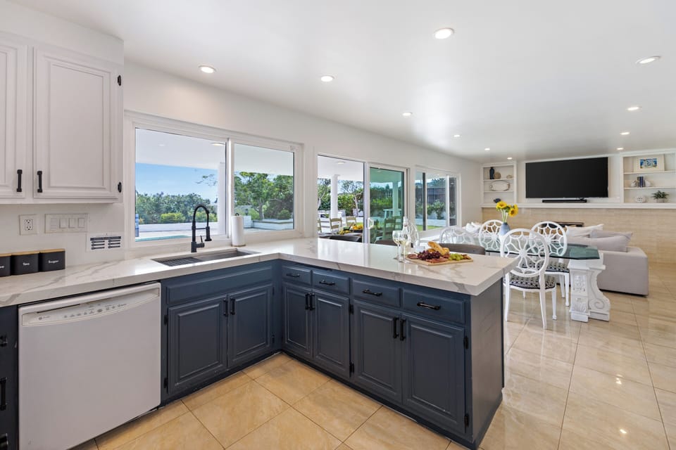 Bright kitchen with pool views, generous counter space, and easy flow into the open living and dining area.