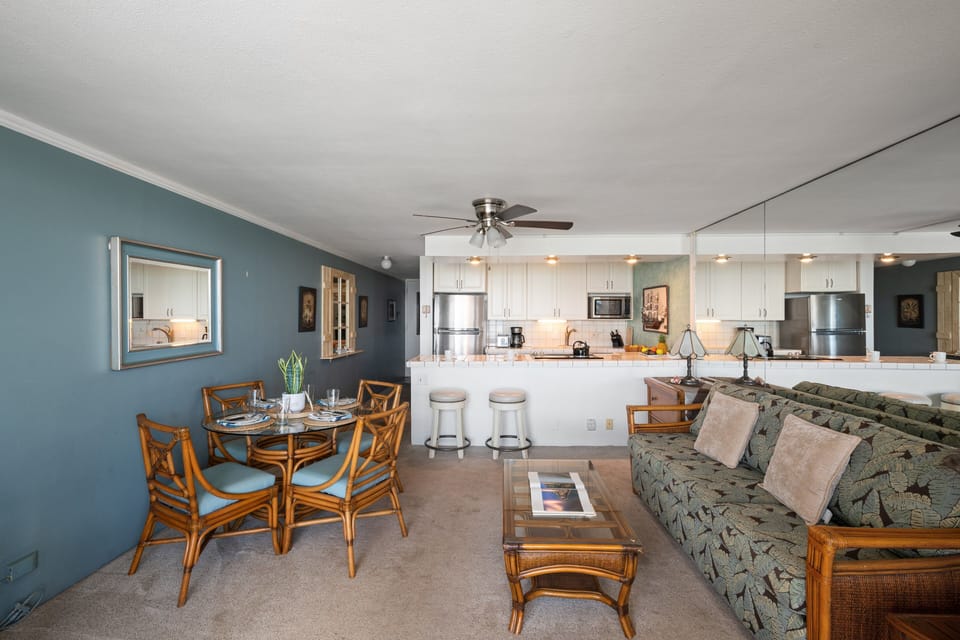 Comfortable living space connected to a fully equipped kitchen with bar seating and dining area.