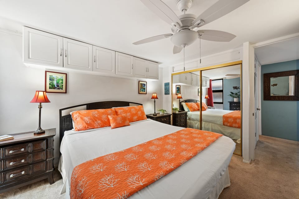 Well‑designed bedroom with mirror accents, built‑ins, and a comfortable queen bed.