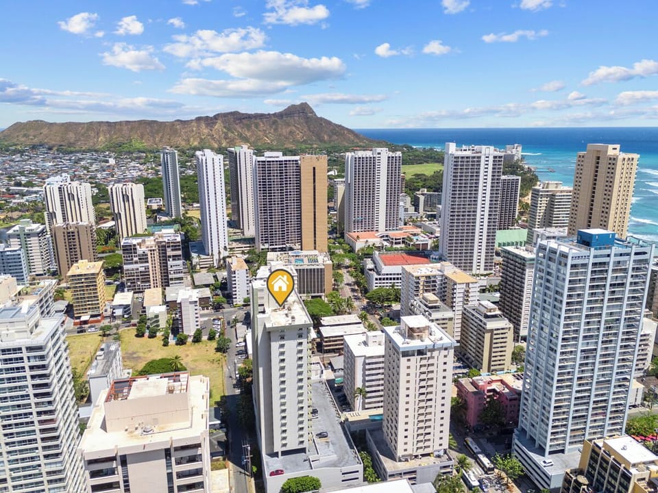 Waikiki Park Heights Building Exterior - Find your Waikiki home base in a sweeping aerial scene framed by Diamond Head, the Pacific, and Honolulu’s lively resort district. Waikiki Park Heights keeps extended stays connected to the neighborhood’s highlights.