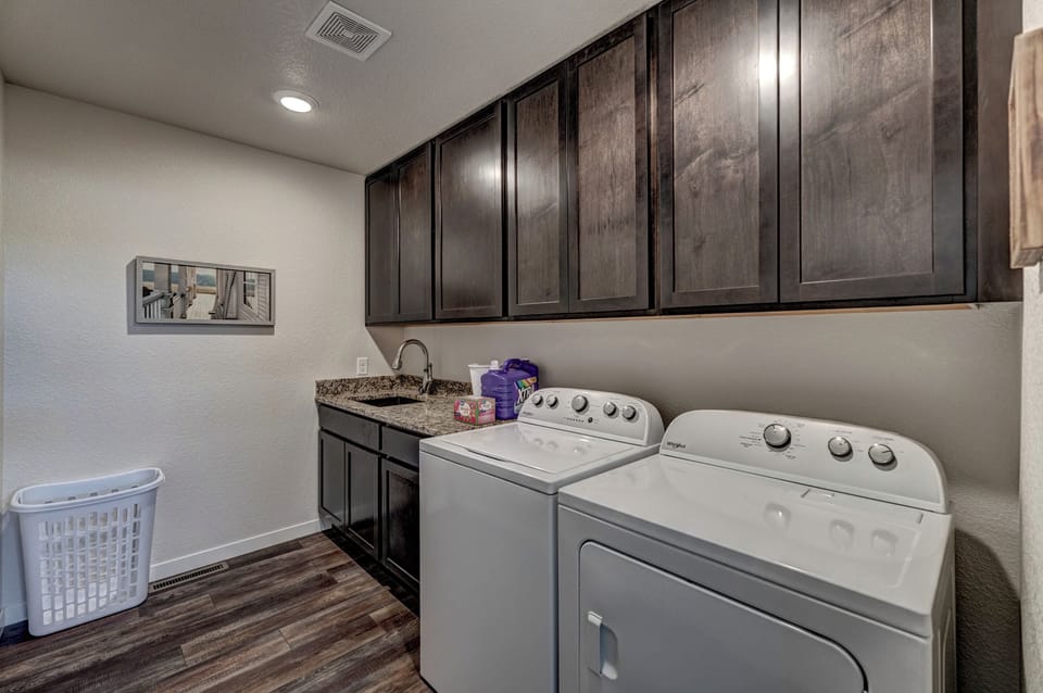 Upper level laundry with washer and dryer, laundry detergent and dryer sheets provided