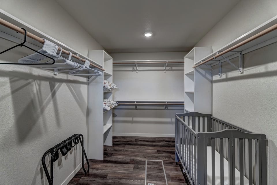 Large walk in closet with portable crib 