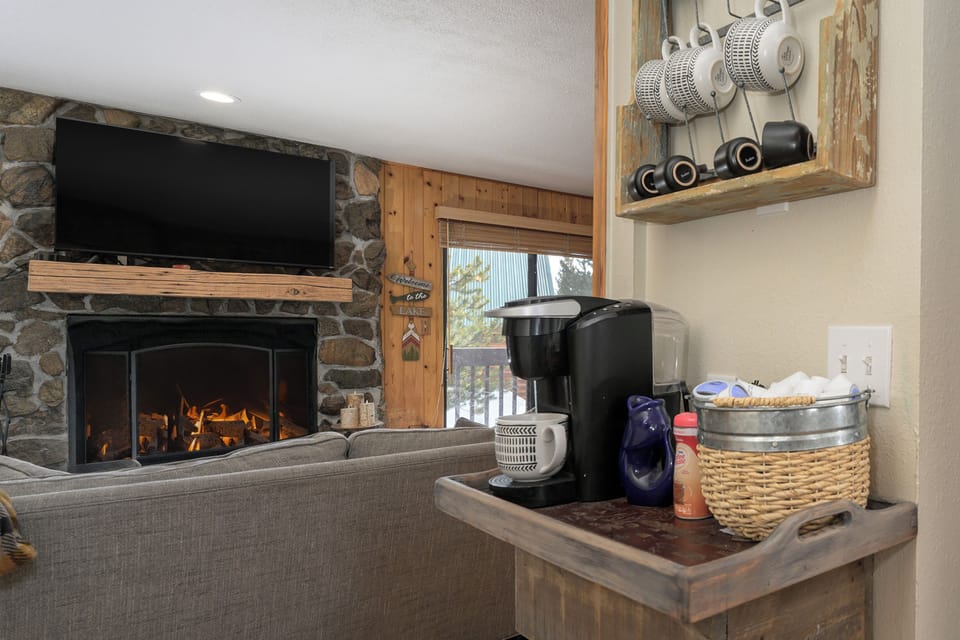 Cozy up with your morning coffee at 1126 Western Road by the stone fireplace while the warm flames dance and flicker in your mountain retreat.