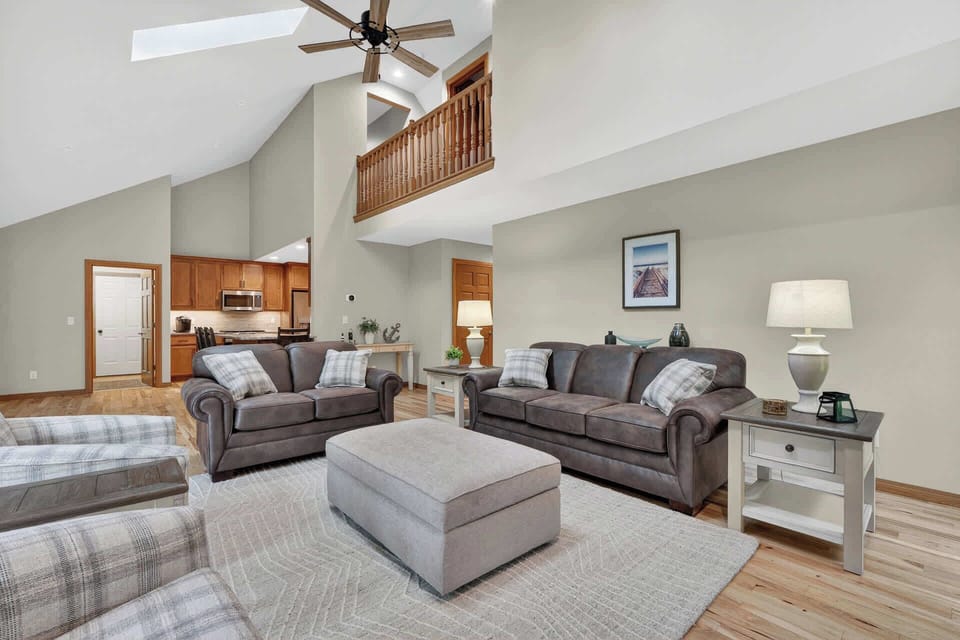 Relax in your bright, open living room with soaring ceilings and cozy couches perfect for gathering after a day exploring. The adjoining kitchen makes it easy to share meals together.