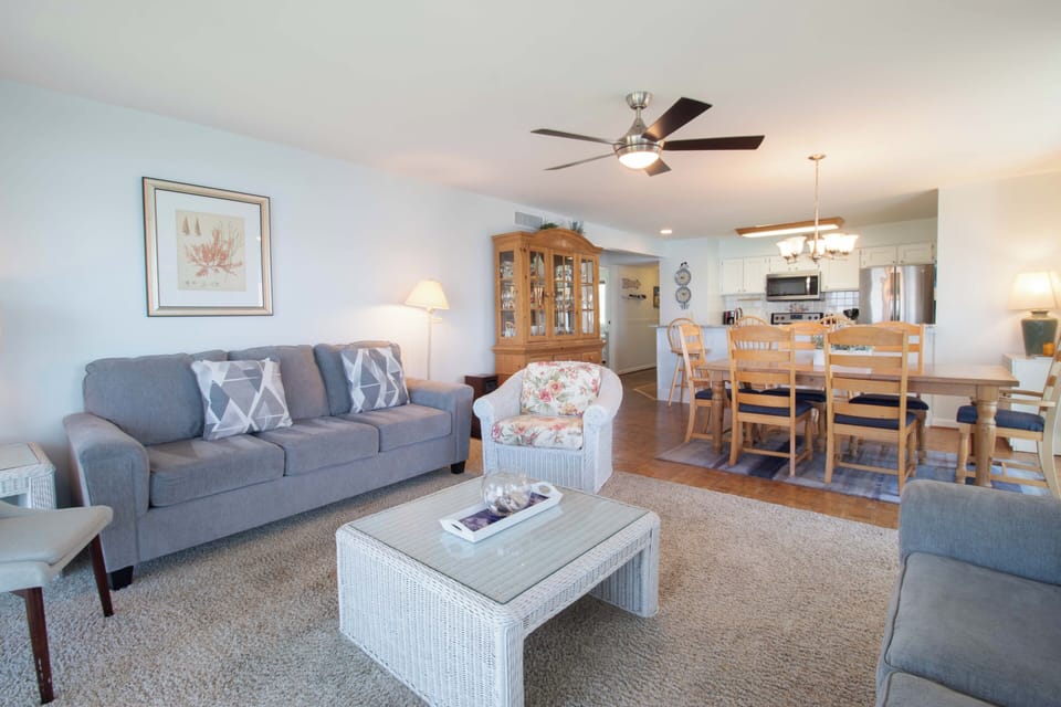 Settle into your open-concept retreat with plush seating and coastal charm. The airy living space flows into a welcoming dining area and fully equipped kitchen, perfect for gathering after a day of exploring.