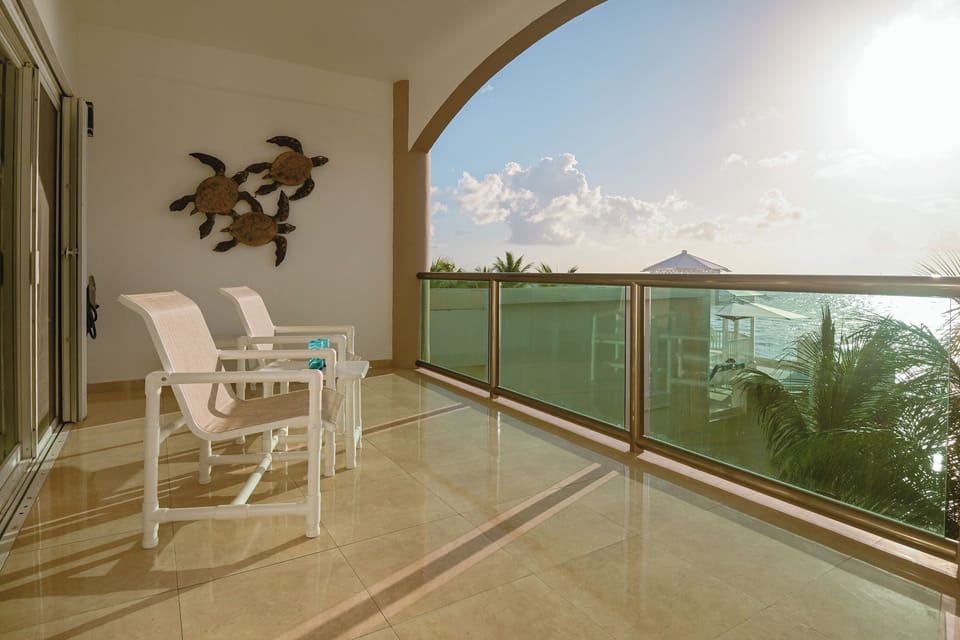 Relax on your private balcony with stunning sea views, tropical breezes, and lounge chairs perfect for soaking up the Caribbean sun.
