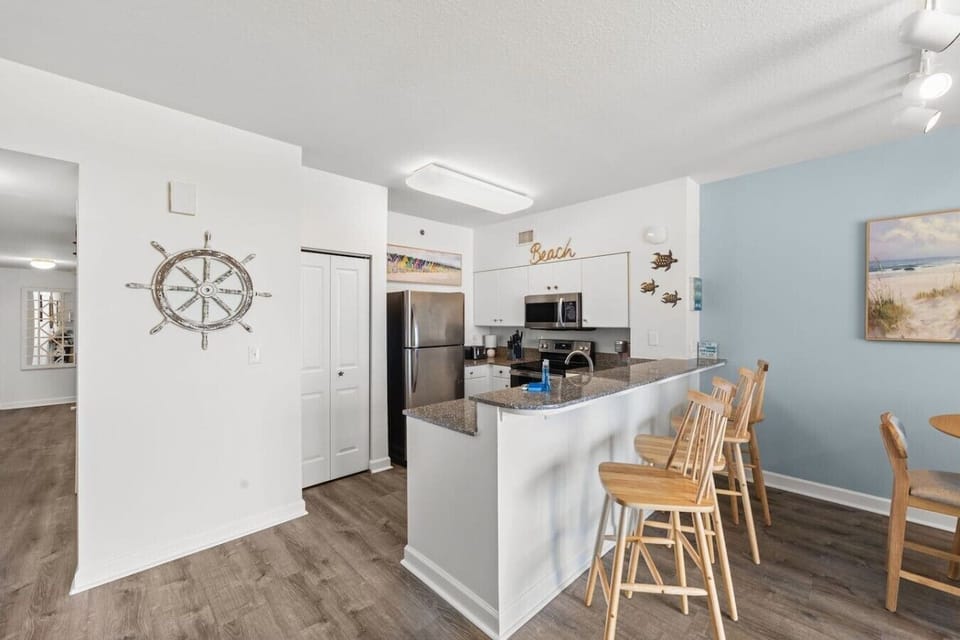 Gather around the oversized breakfast bar and enjoy an open coastal kitchen designed for easy meals and conversation.
