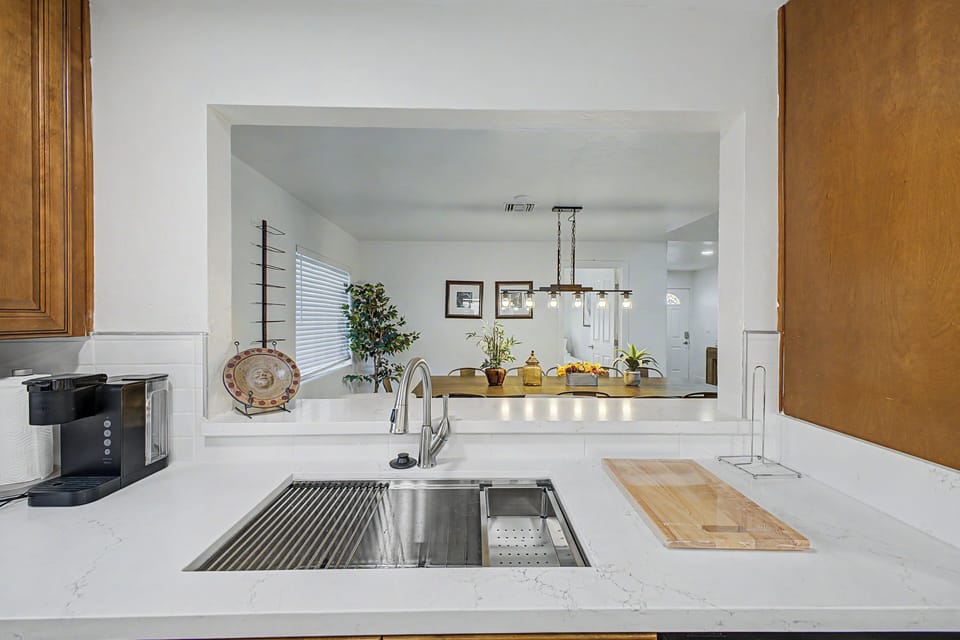 Custom chefs kitchen with quartz countertop and pass through bar to dining room 