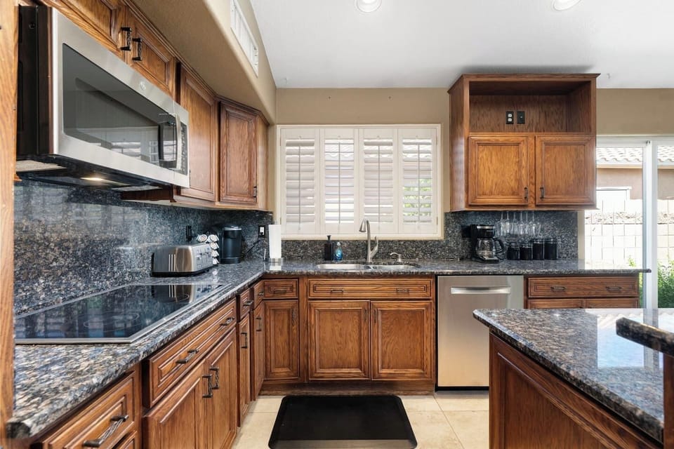 Fully equipped with stainless steel appliances, deep granite counters, and ample cabinet storage — cooking for the whole group has never been easier.