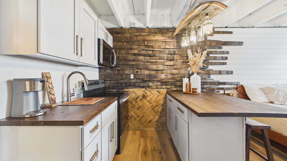 Full kitchen with bar stool seating on counter with all the cooking essentials. Fully updated as well.