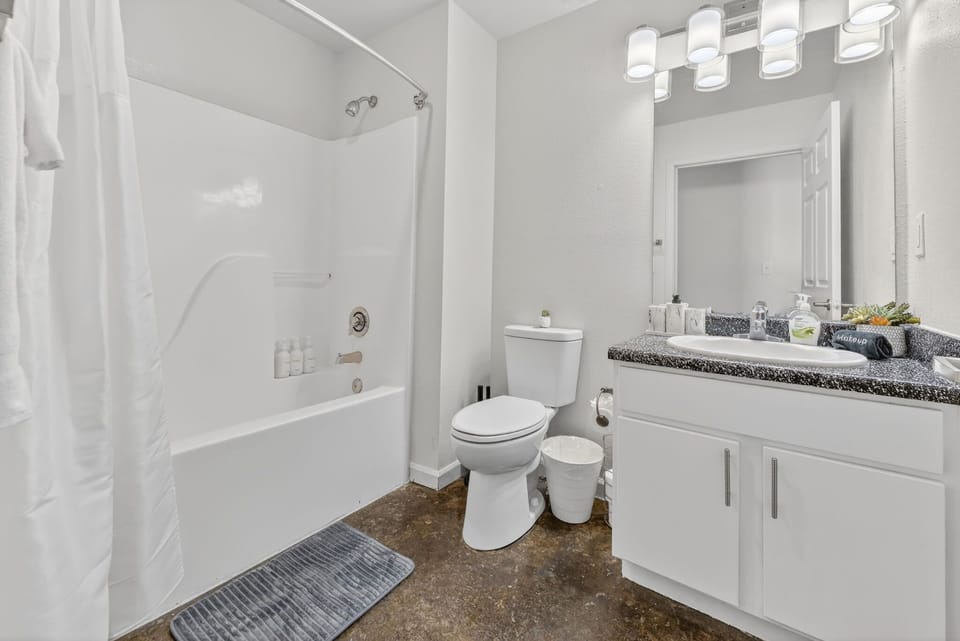 Bright full bathroom with a modern vanity and a convenient tub-and-shower combination.