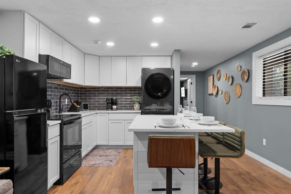 The chic, open kitchen offers ample space & all the comforts of home​