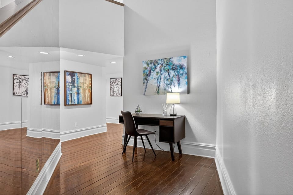 Work area in the entry hallway, beyond is the open living area.
