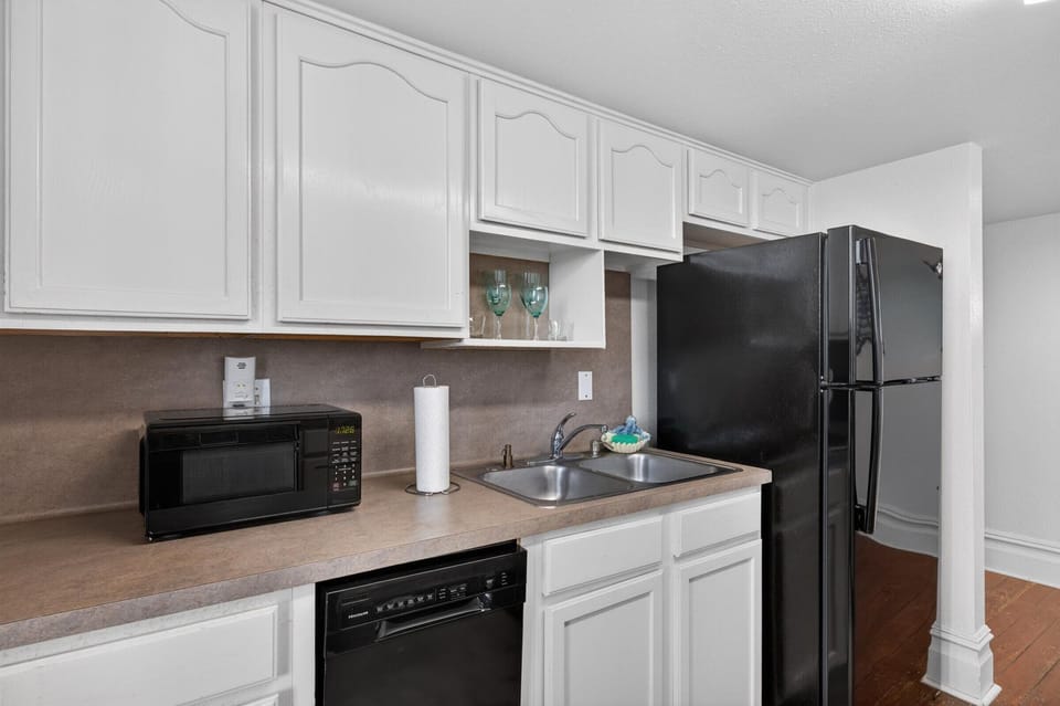 Kitchen with modern appliances and ample white cabinets.