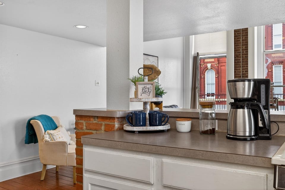 Enjoy coffee with historic street views, or step out onto the balcony patio.