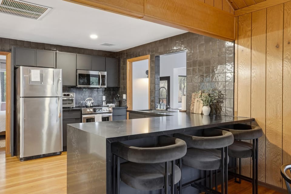 The fully stocked kitchen has plenty of space to make meals and hang out.