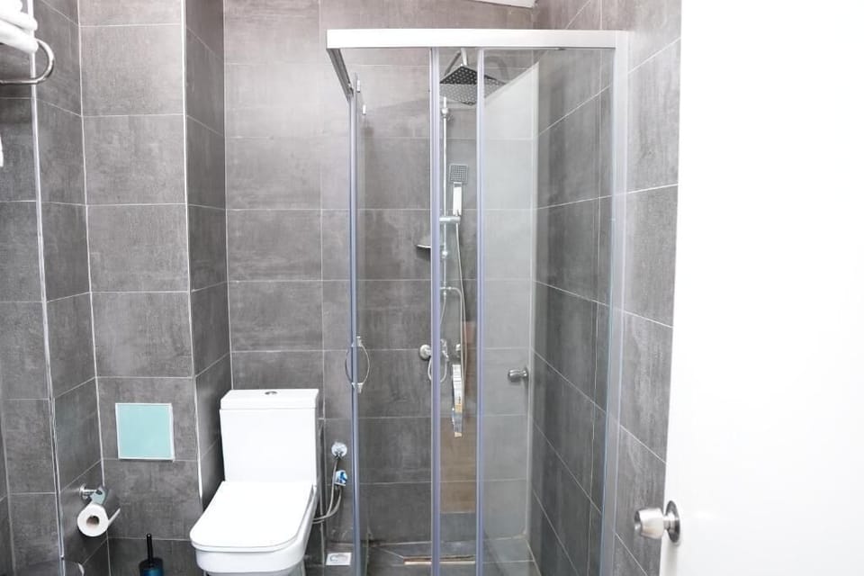 Shower, hair dryer, slippers, towels